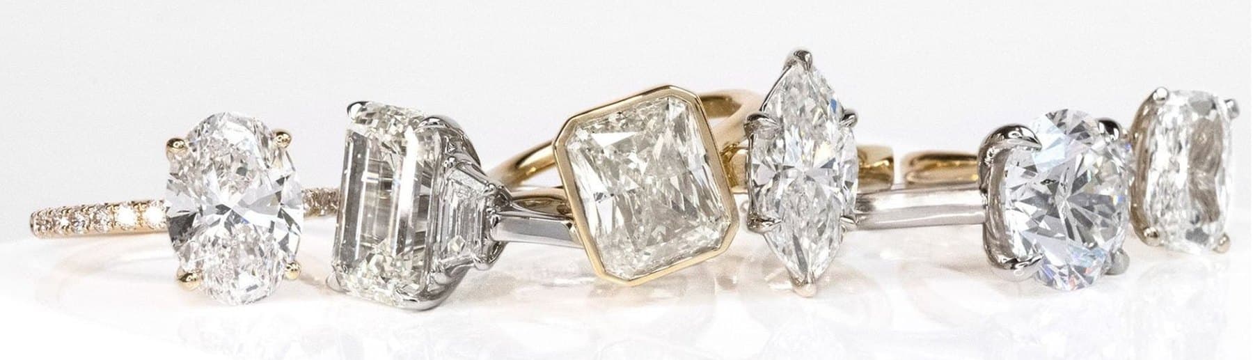 Six bespoke Buchroeders engagement rings on a white plinth