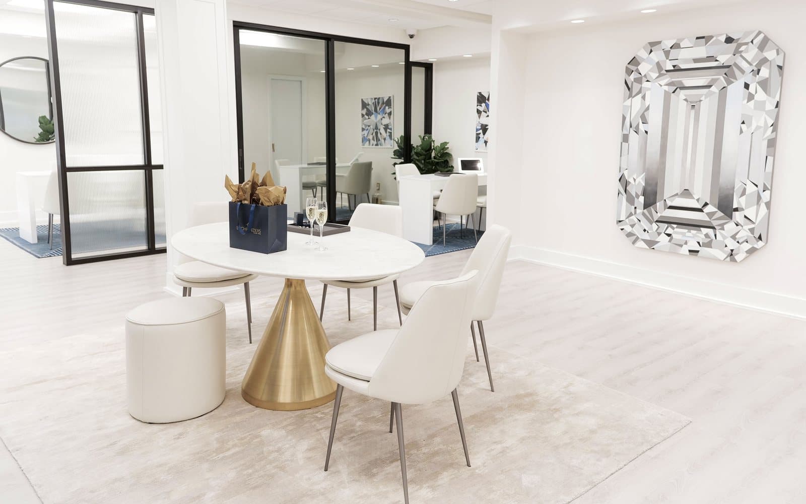 The bright white Buchroeders consultation area with a marble table and private consultation rooms