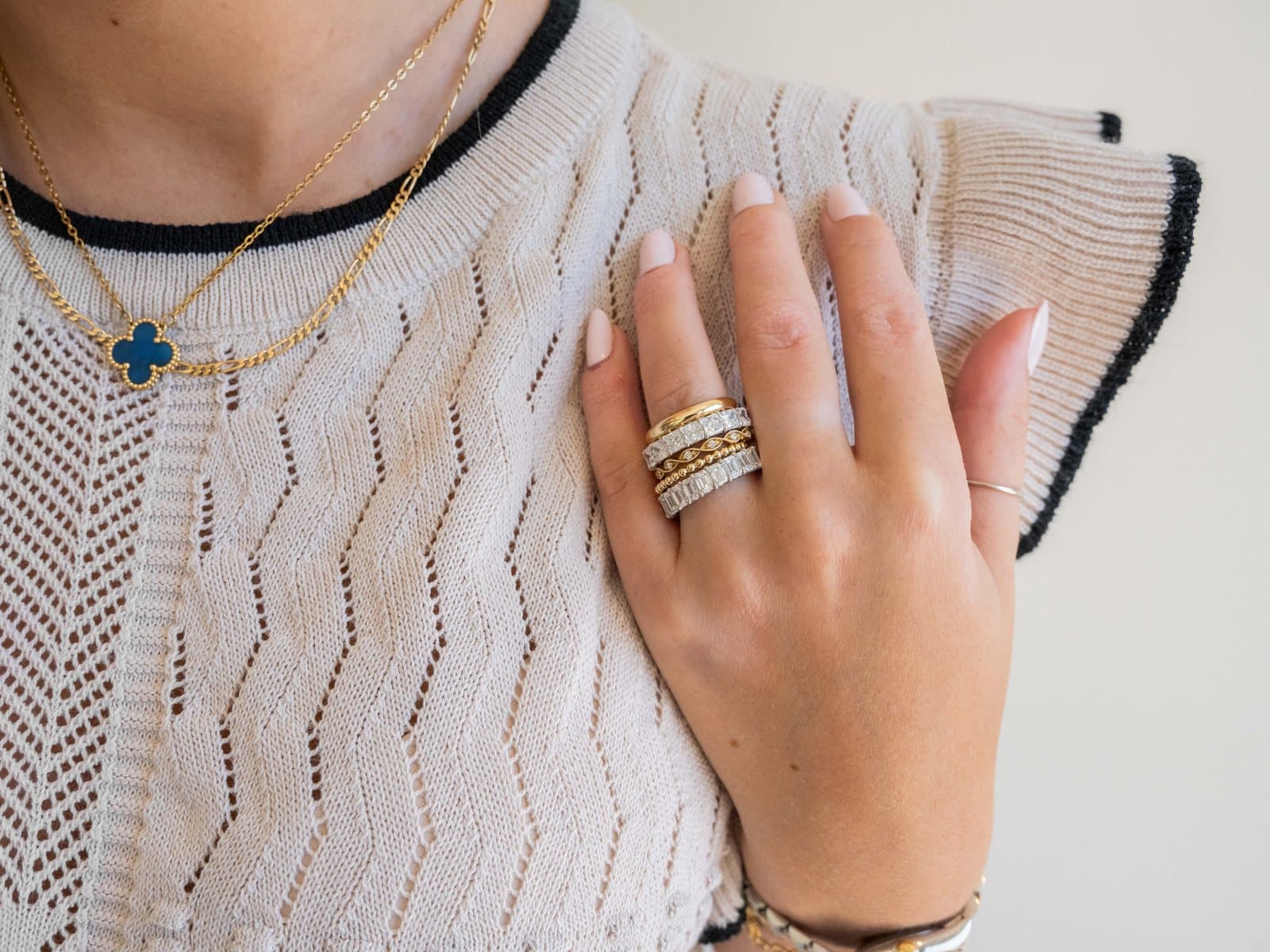 A stack of Buchroeders diamond and gold wedding bands worn on a hand